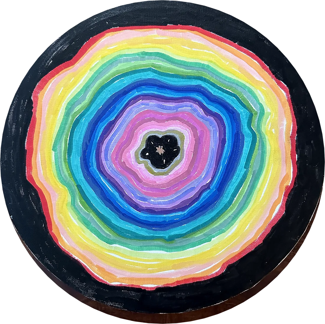 Rings, by Confetti. Rainbow rings growing out from a small dark center, inside a black circle.